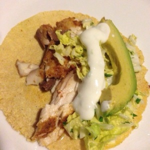 Fish tacos with Napa cabbage, cilantro, lime cream sauce, and fresh avocado