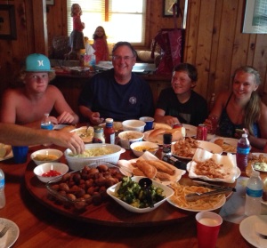 My stepdad and some of the kids enjoying a seafood feast in our dining room